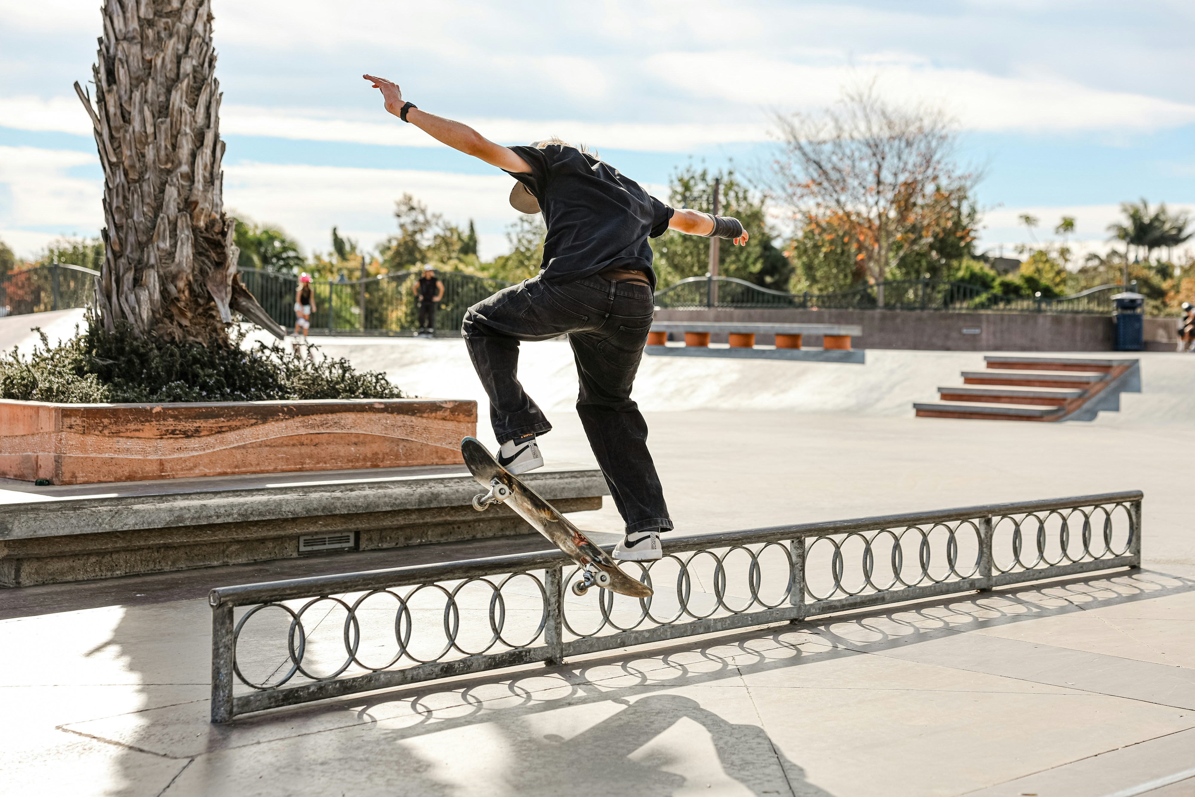 A man riding a skateboard up the side of a metal rail