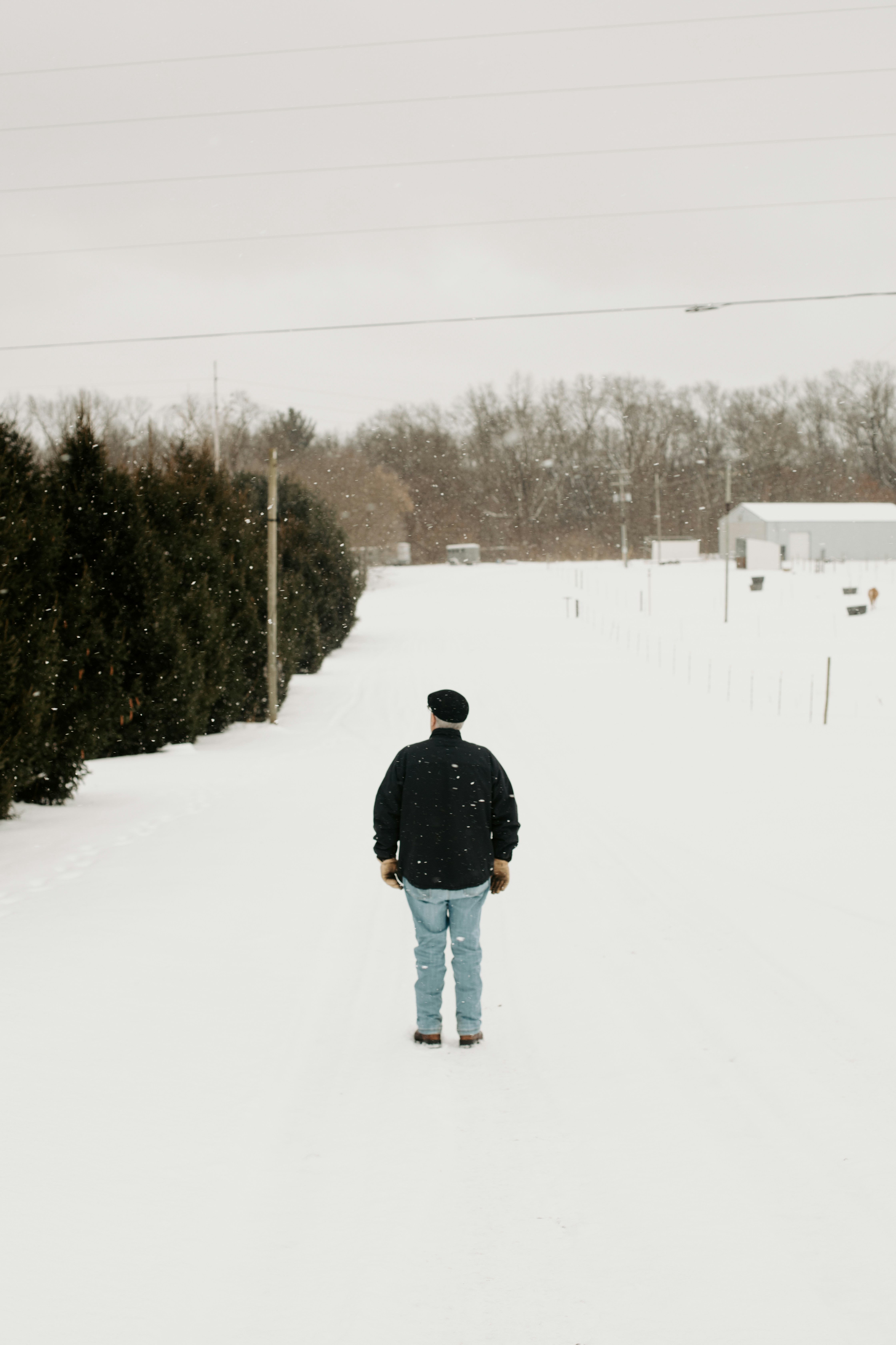 A person standing in the middle of a snow covered field