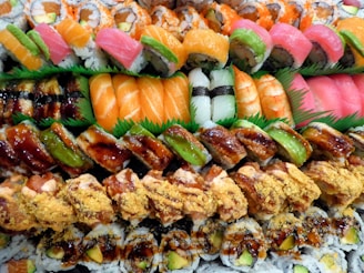 A variety of sushi is displayed on a platter