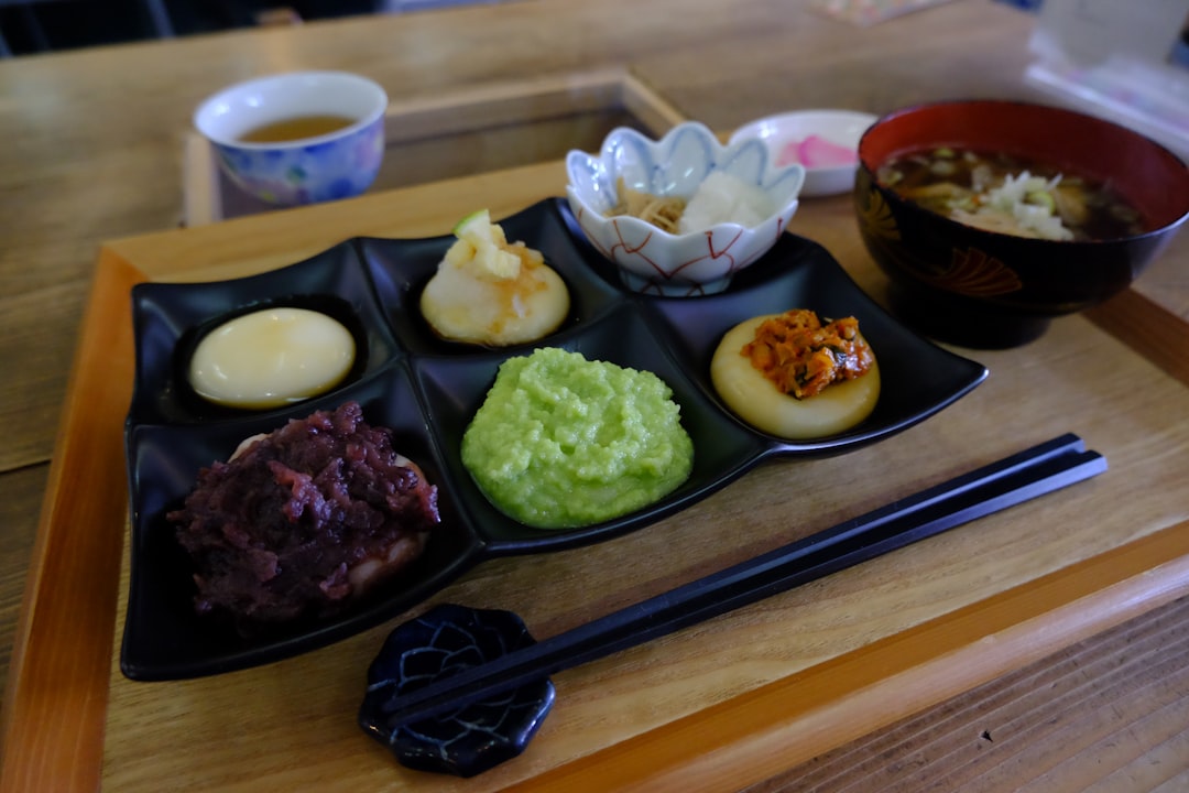 A tray of food on a table with chopsticks