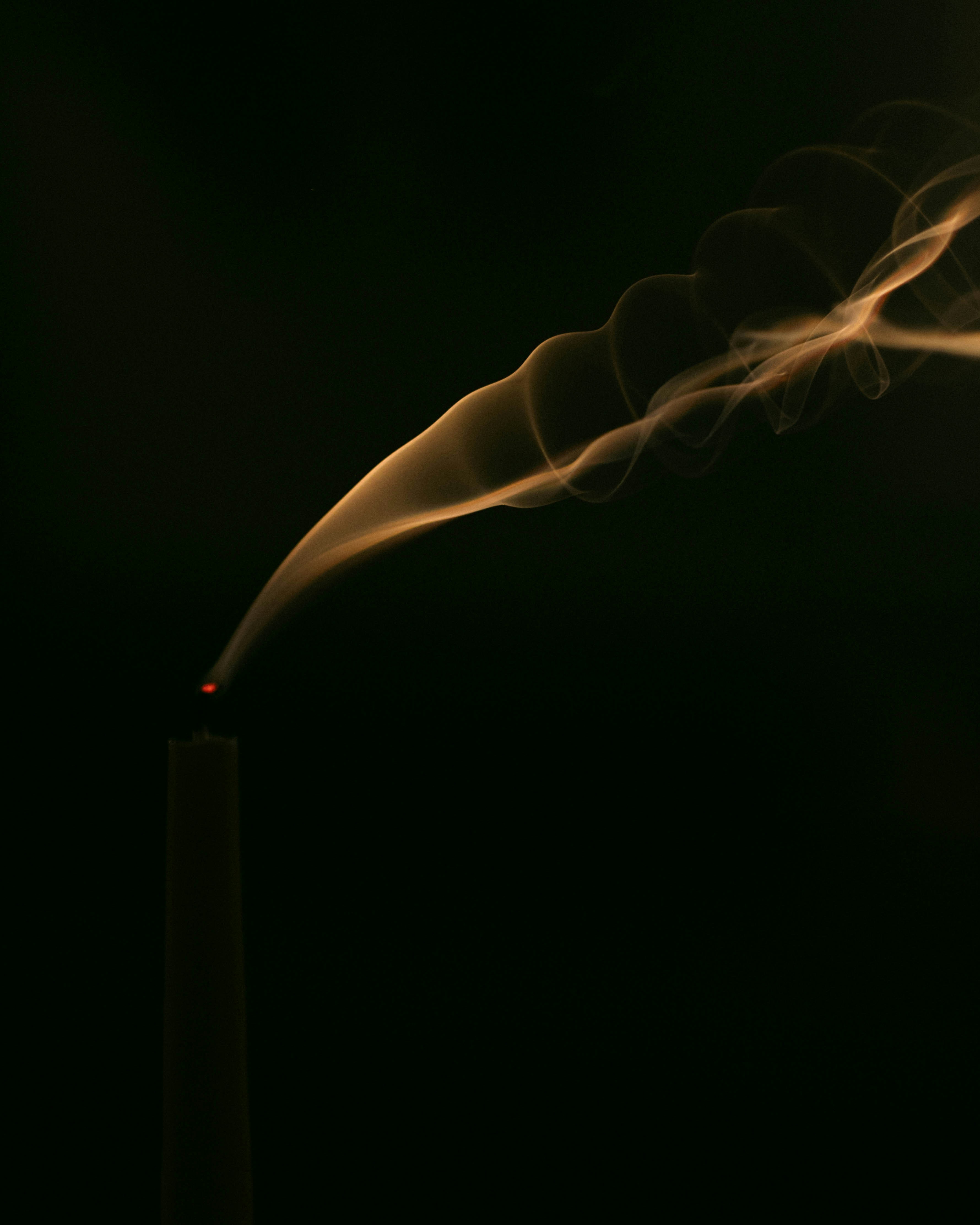A lit matchstick with smoke coming out of it