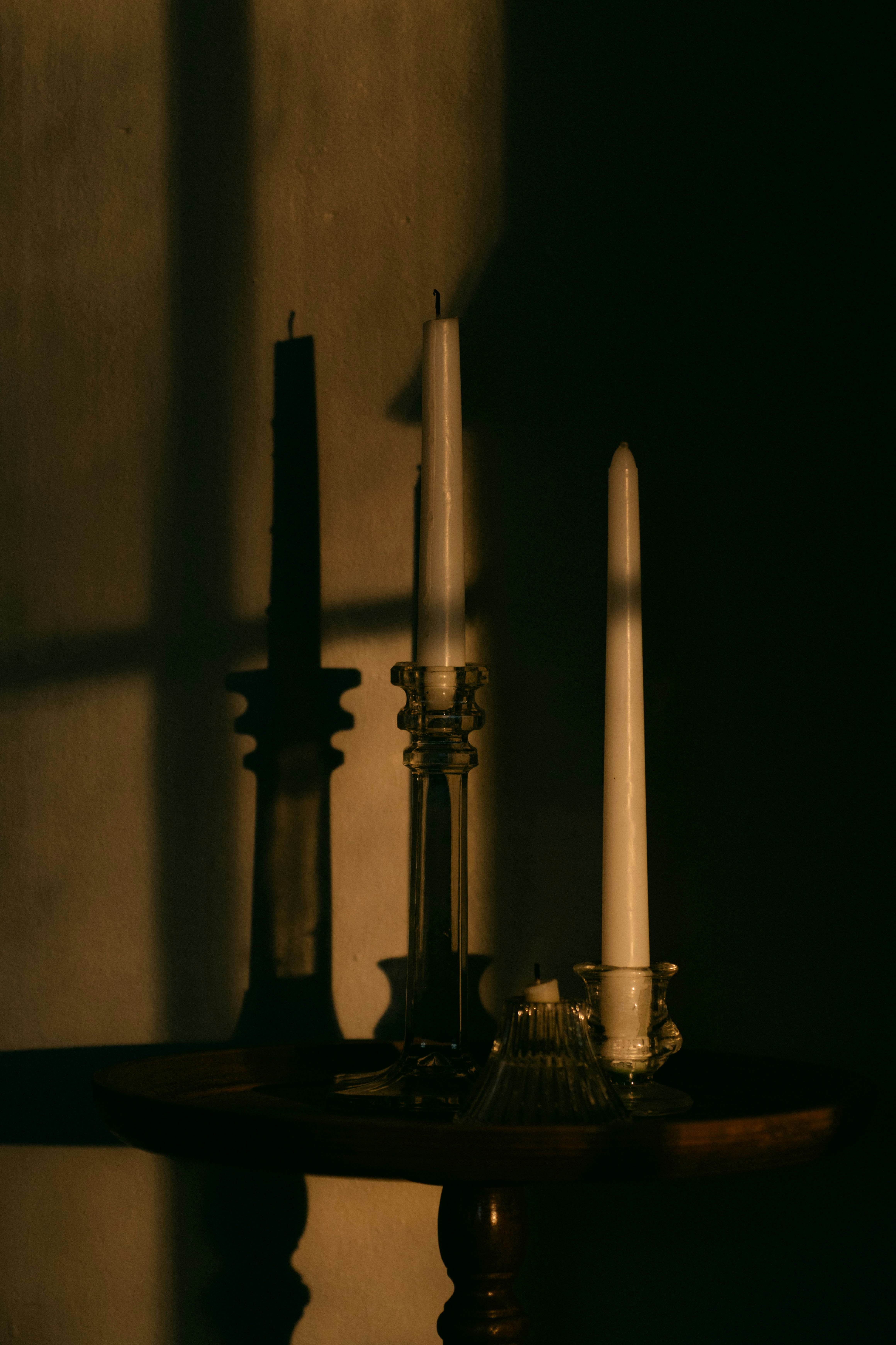 A table topped with two candles and a candle holder