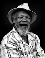 A black and white photo of a man laughing