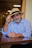 A man sitting at a table wearing a hat