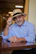 A man sitting at a table wearing a hat