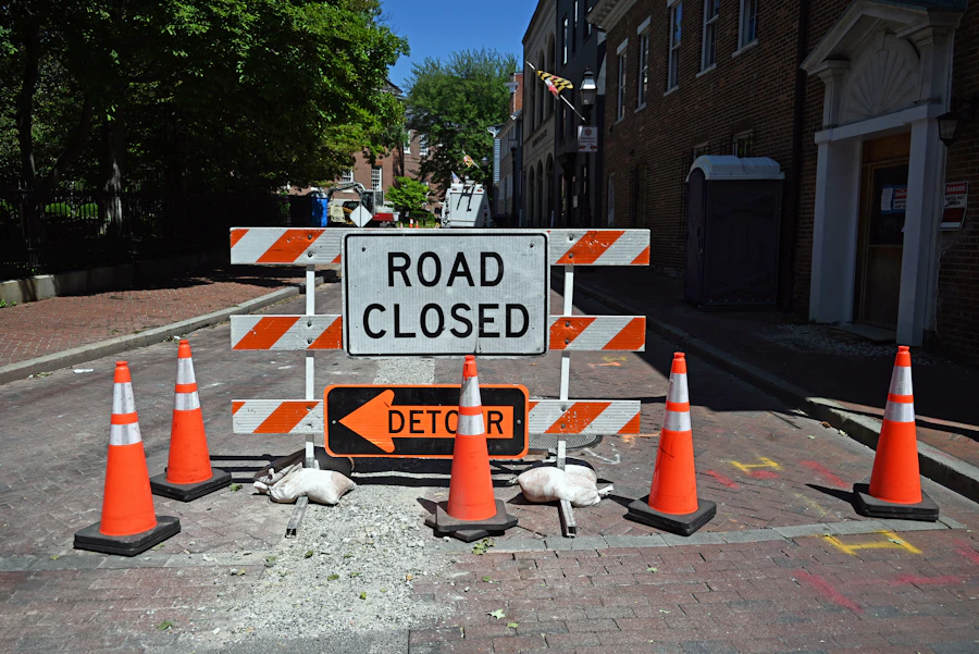 Road closed sign with orange traffic cones