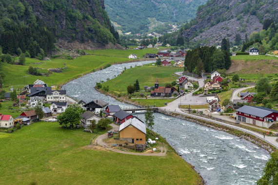 A river running through a lush green valley