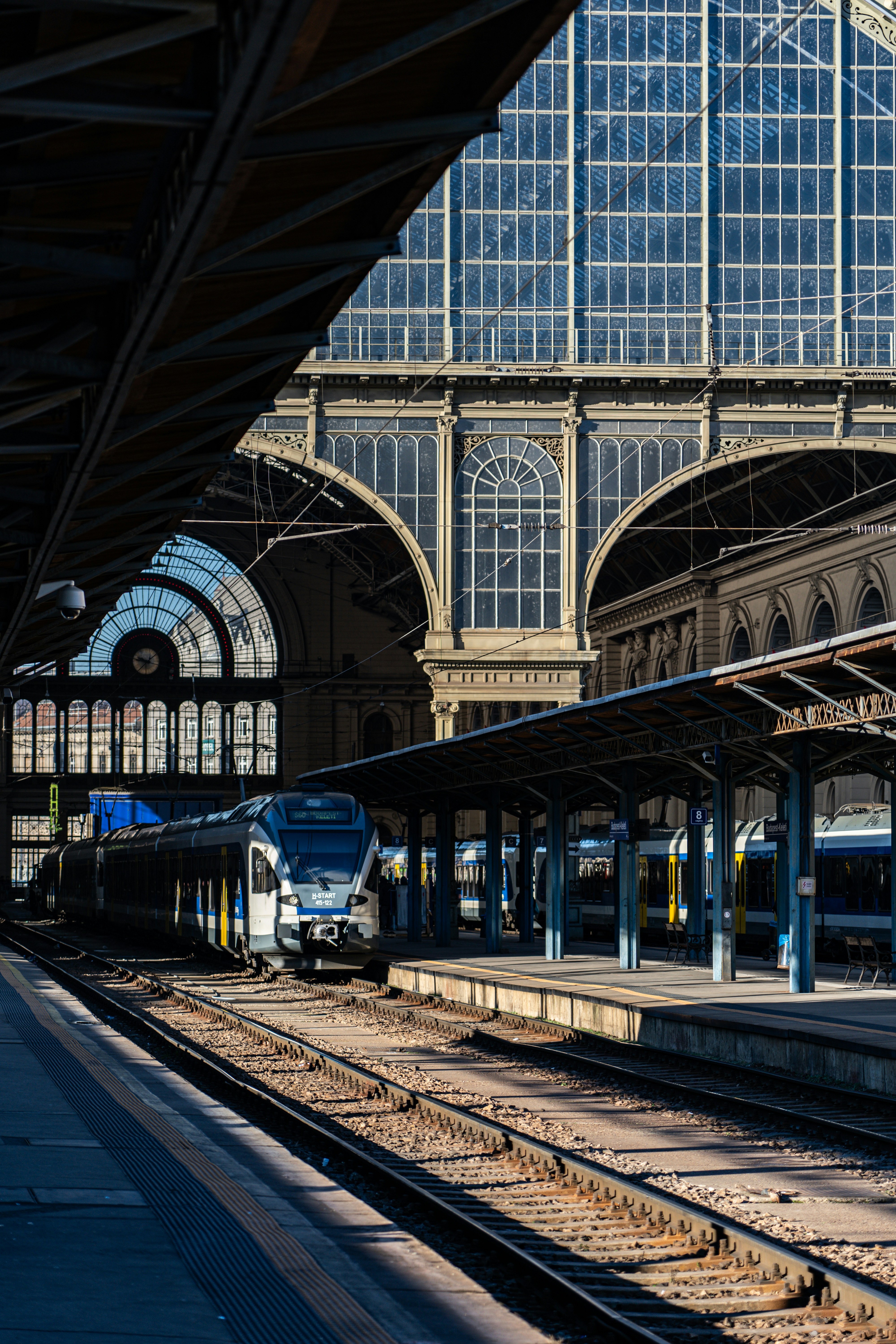 A train station with a train on the tracks photo – Free Building Image ...