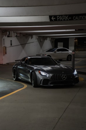 A car parked in a parking garage next to another car