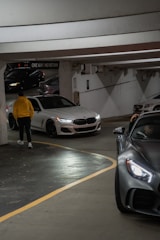 A parking garage with several cars parked in it
