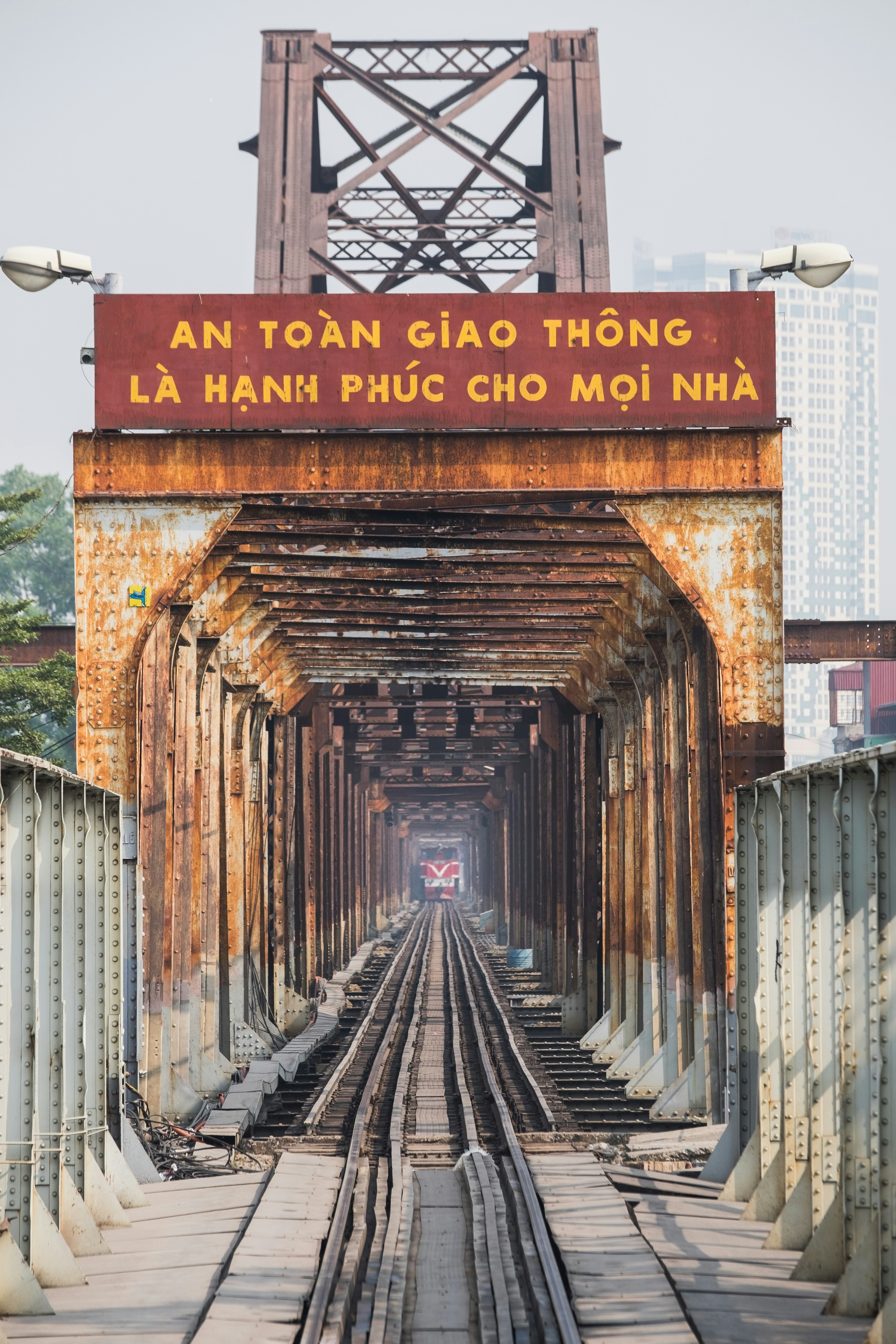 A train track going through a tunnel with a sign above it