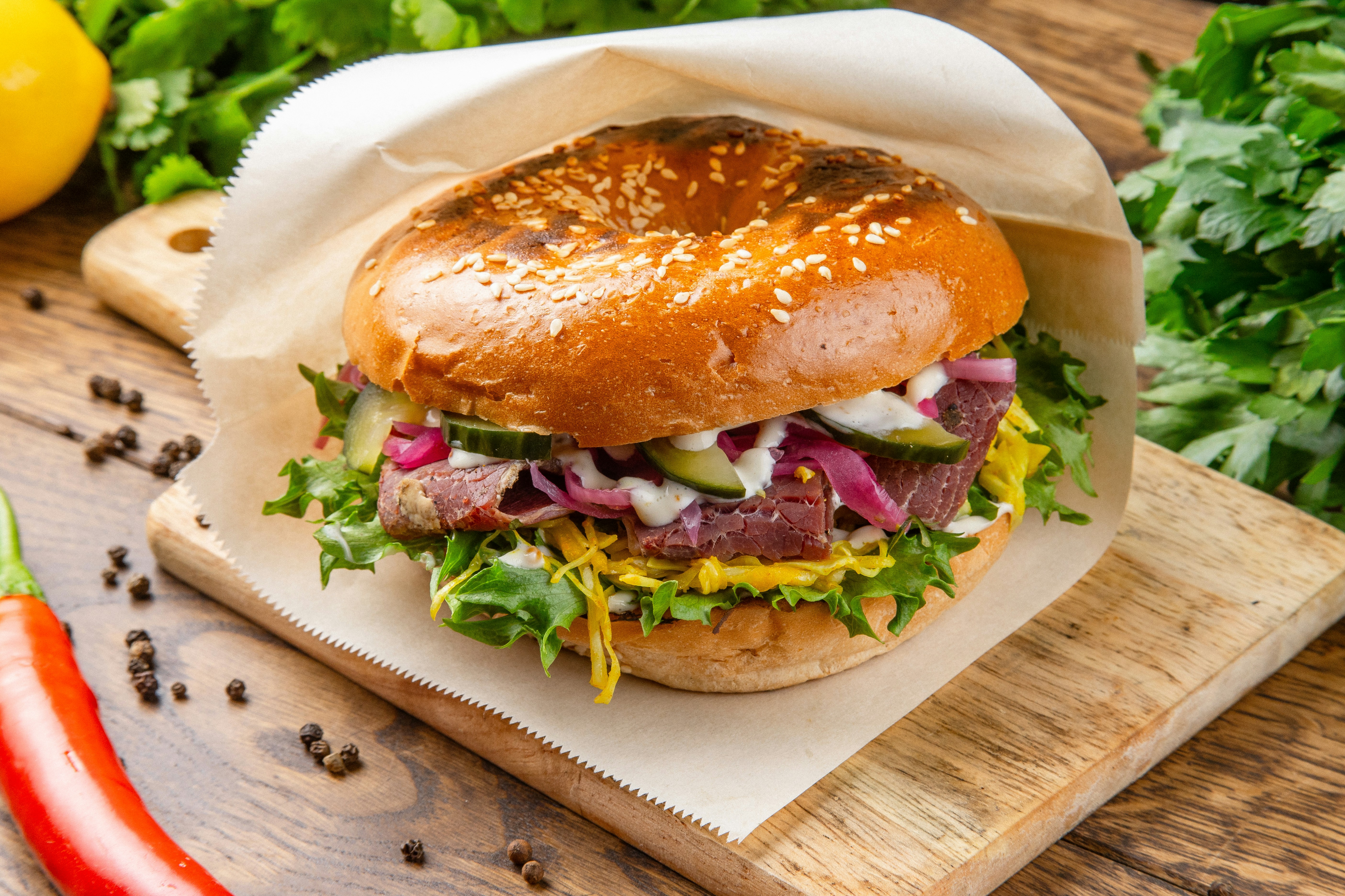 A sandwich sitting on top of a wooden cutting board