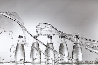 A group of bottles of water being filled with water