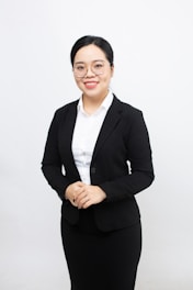 A woman in a business suit posing for a picture
