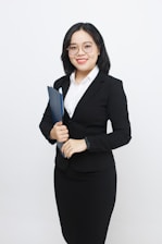 A woman in a business suit holding a folder