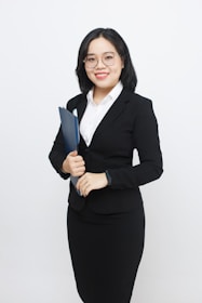 A woman in a business suit holding a folder