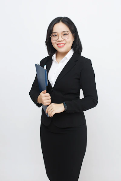 A woman in a business suit holding a folder