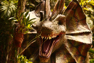 A close up of a dragon statue in a forest