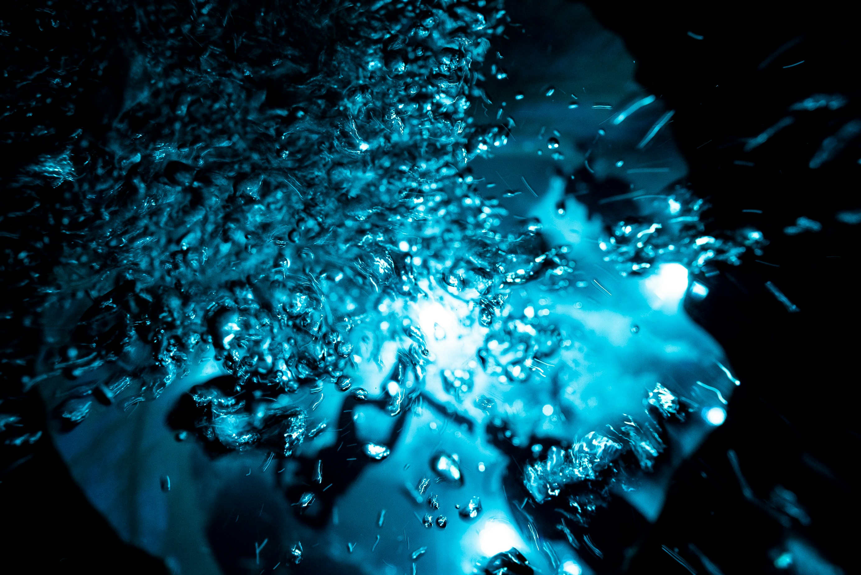 A close up of water droplets on a black surface