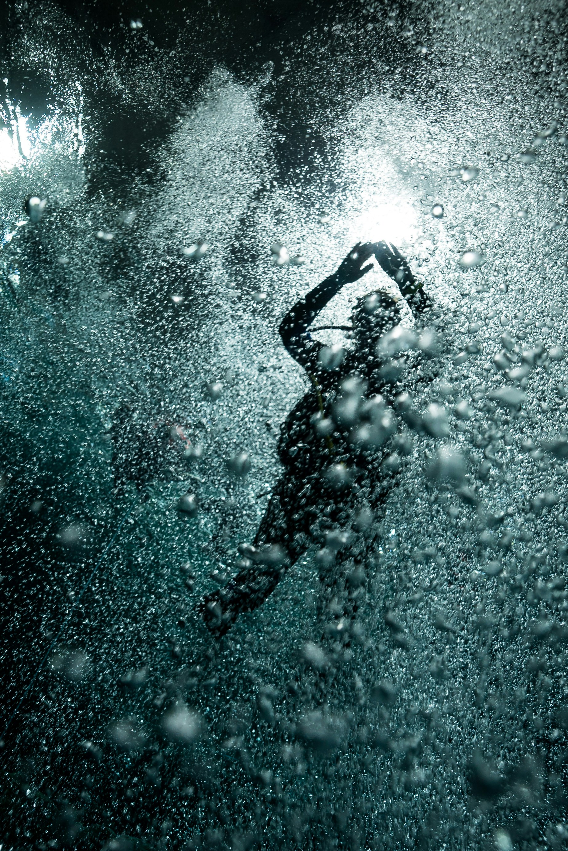 A person swimming in the water with bubbles