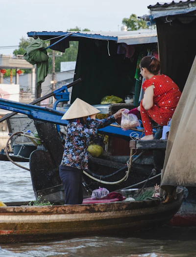 A woman standing on a boat in a body of water