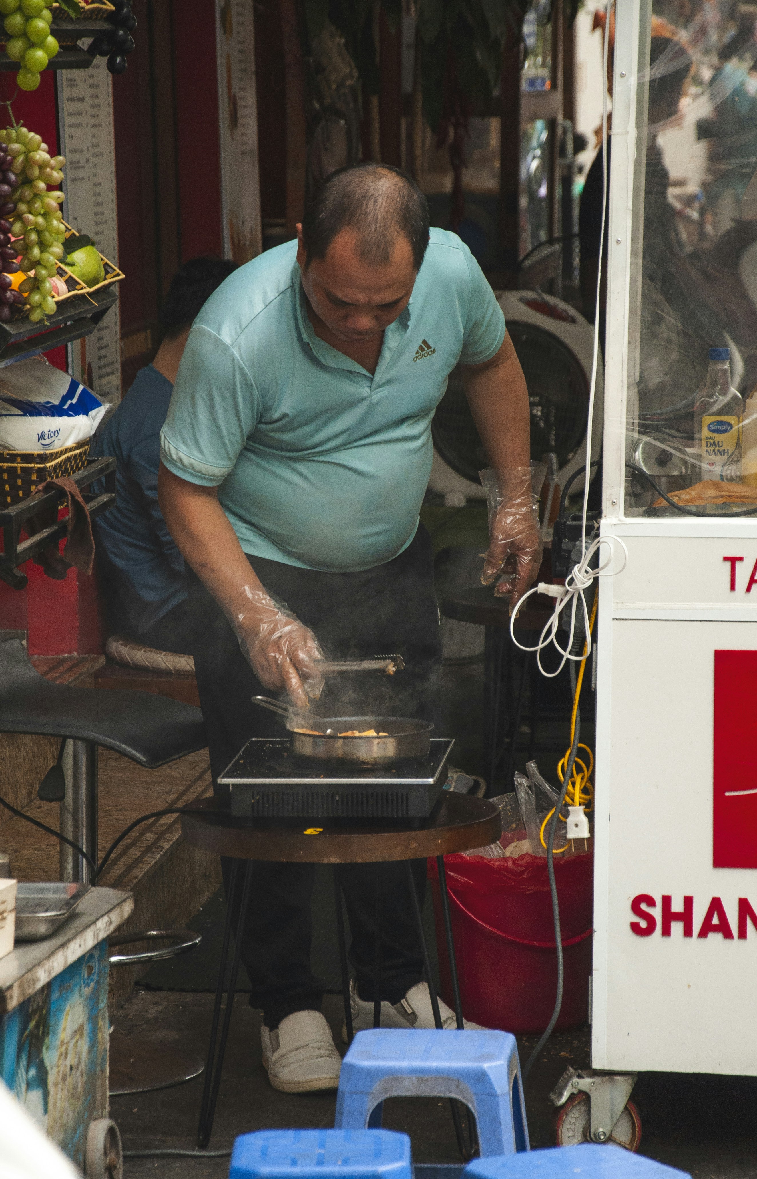 A man cooking food on a grill outside