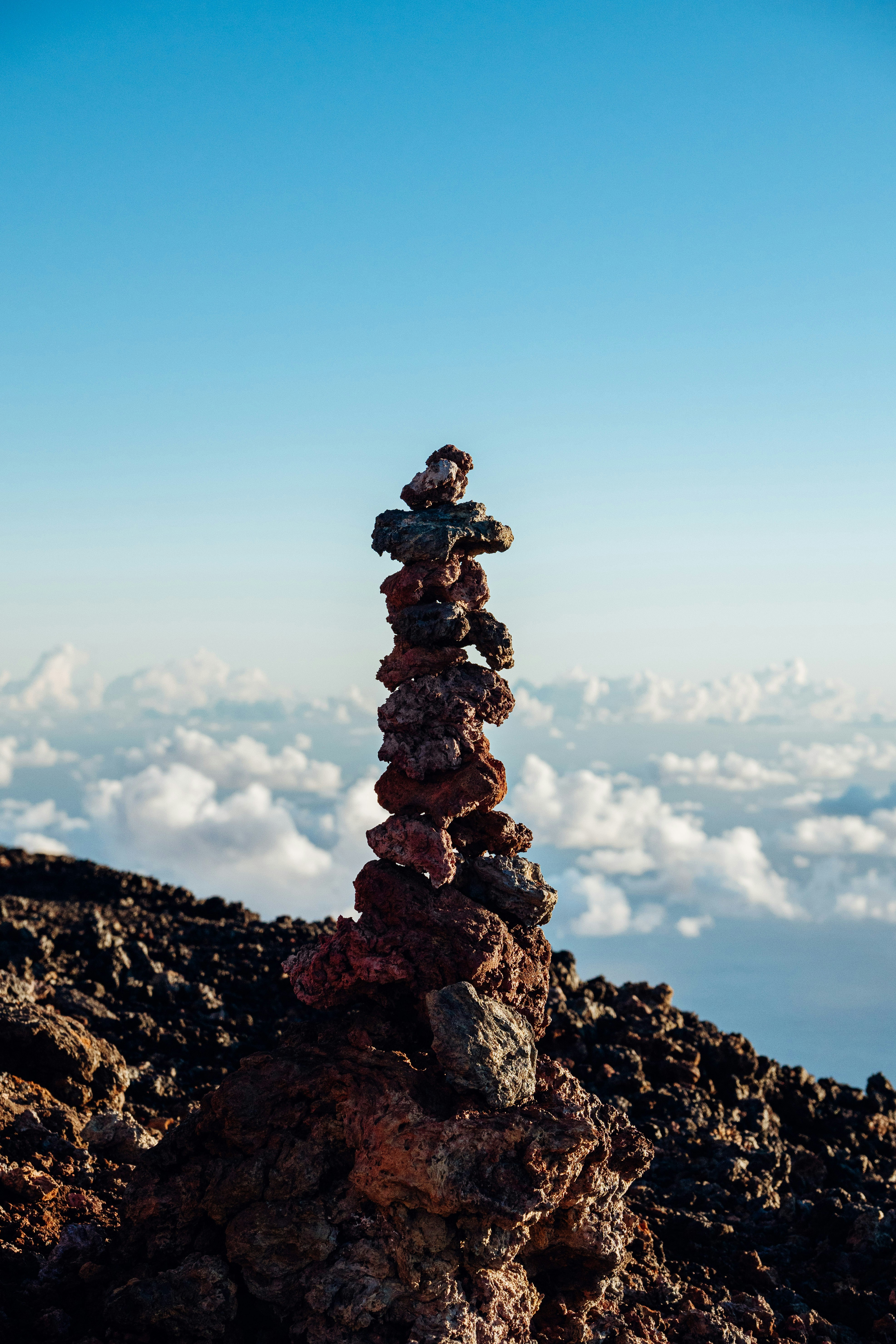 A stack of rocks sitting on top of a mountain photo – Free Piton de la ...
