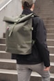 A man walking up some stairs with a backpack on his back