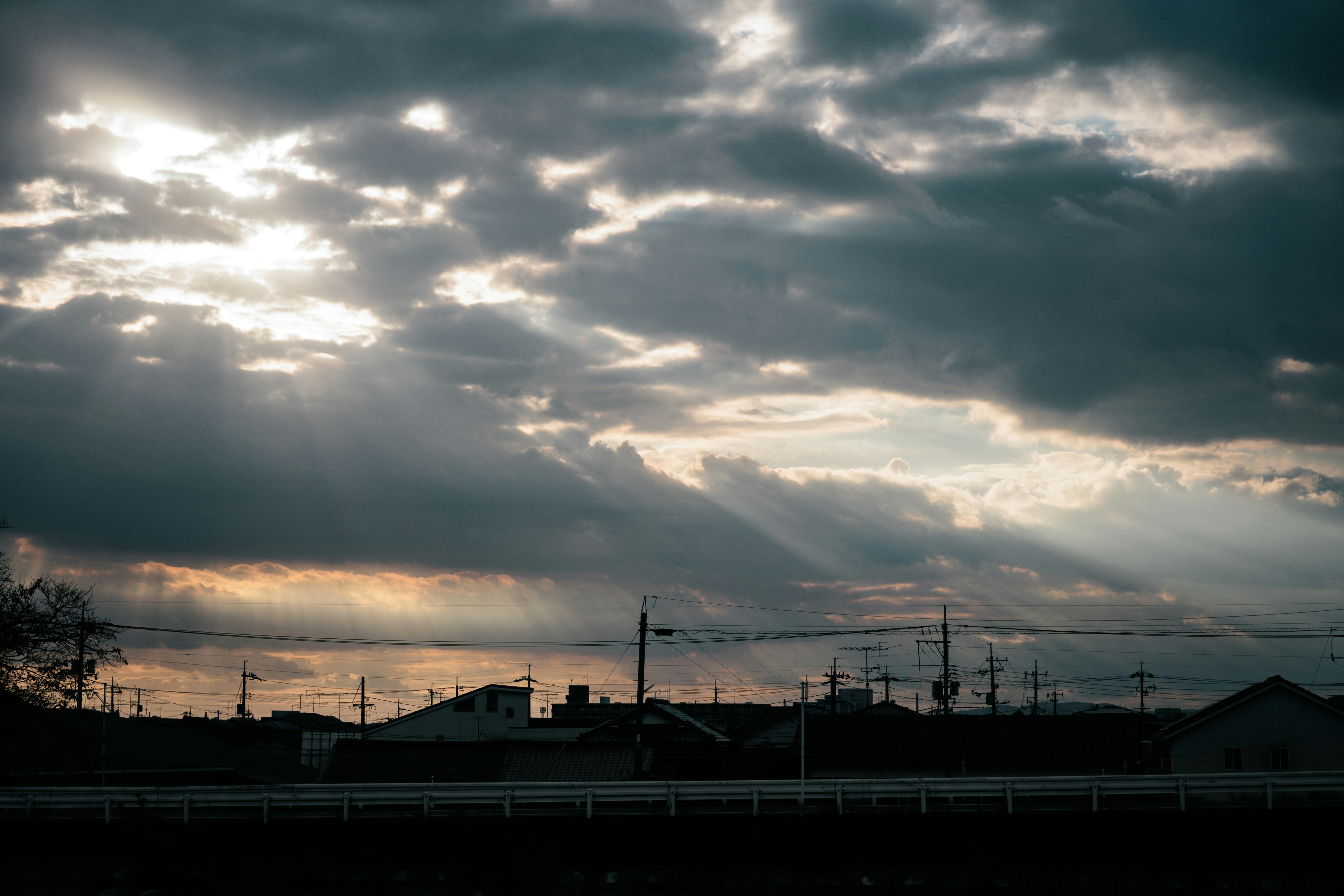 The sun is shining through the clouds in the sky