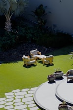 A garden with a lawn and seating area