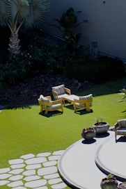 A garden with a lawn and seating area