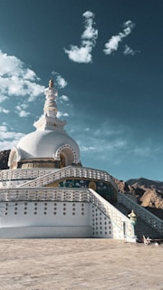 A large white building sitting on top of a sandy beach