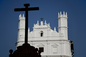 A large white building with a cross on top of it