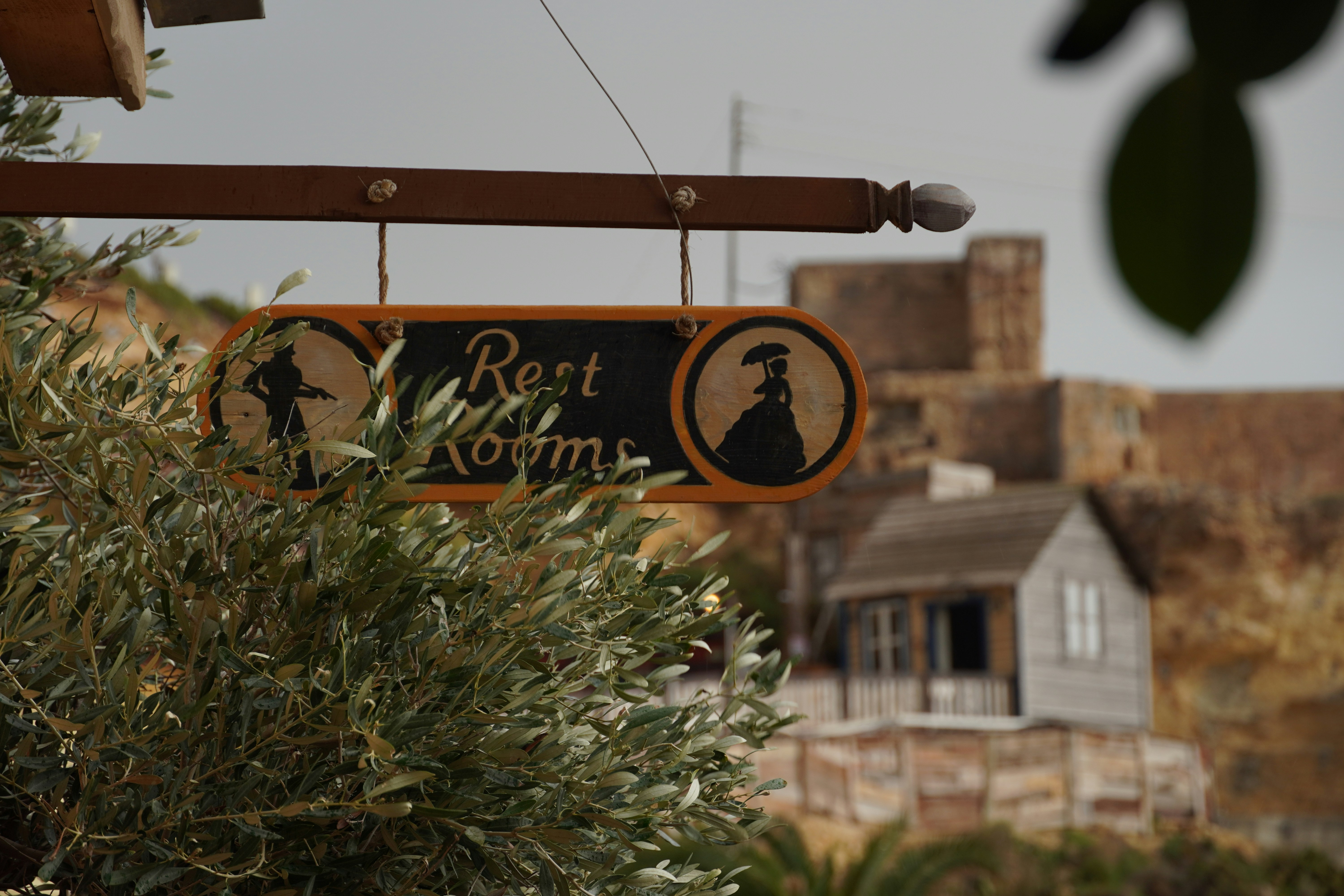 A sign hanging from the side of a building