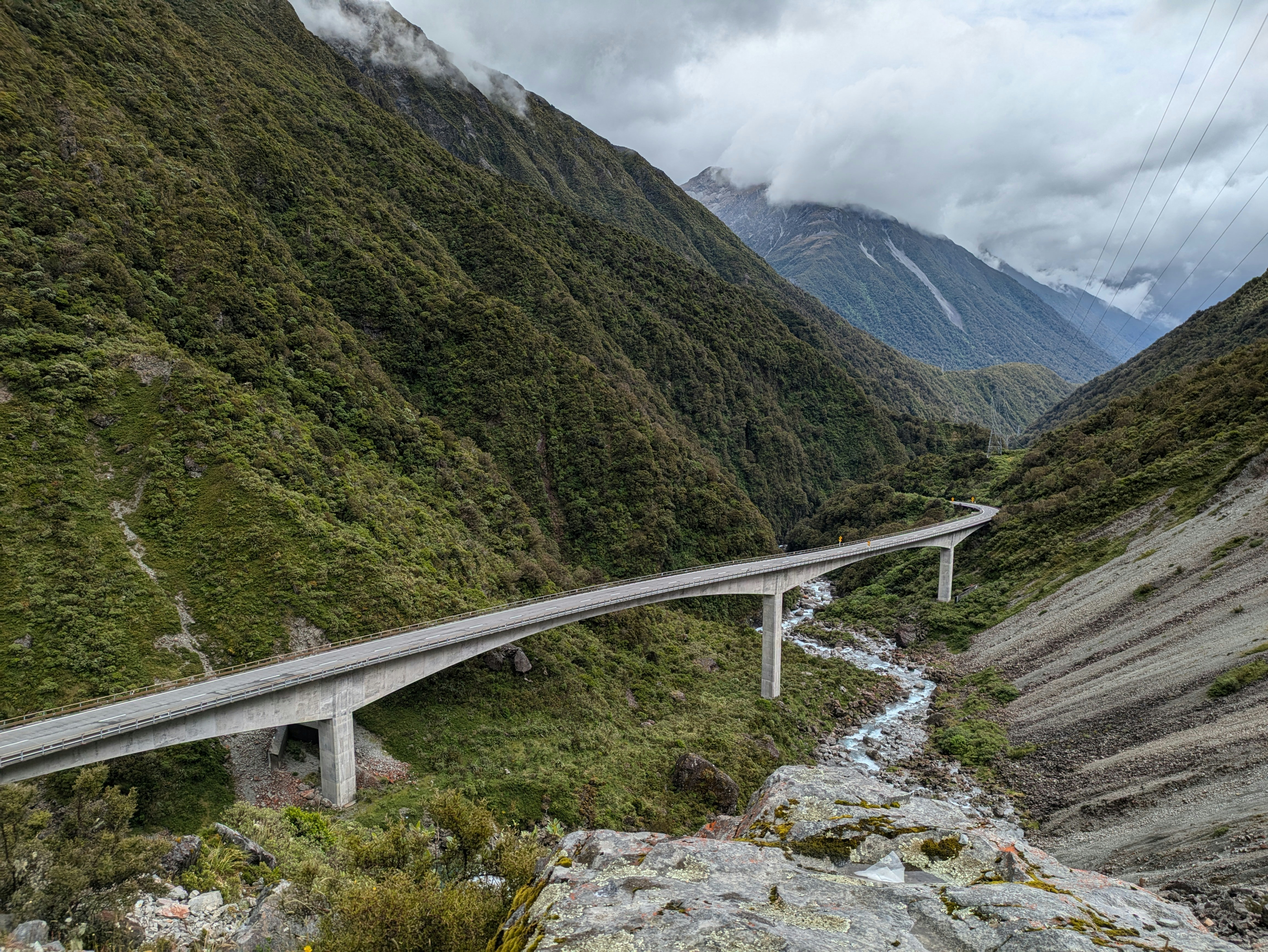 A view of a mountain with a road going through it