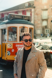 A man standing in front of a trolley on a street