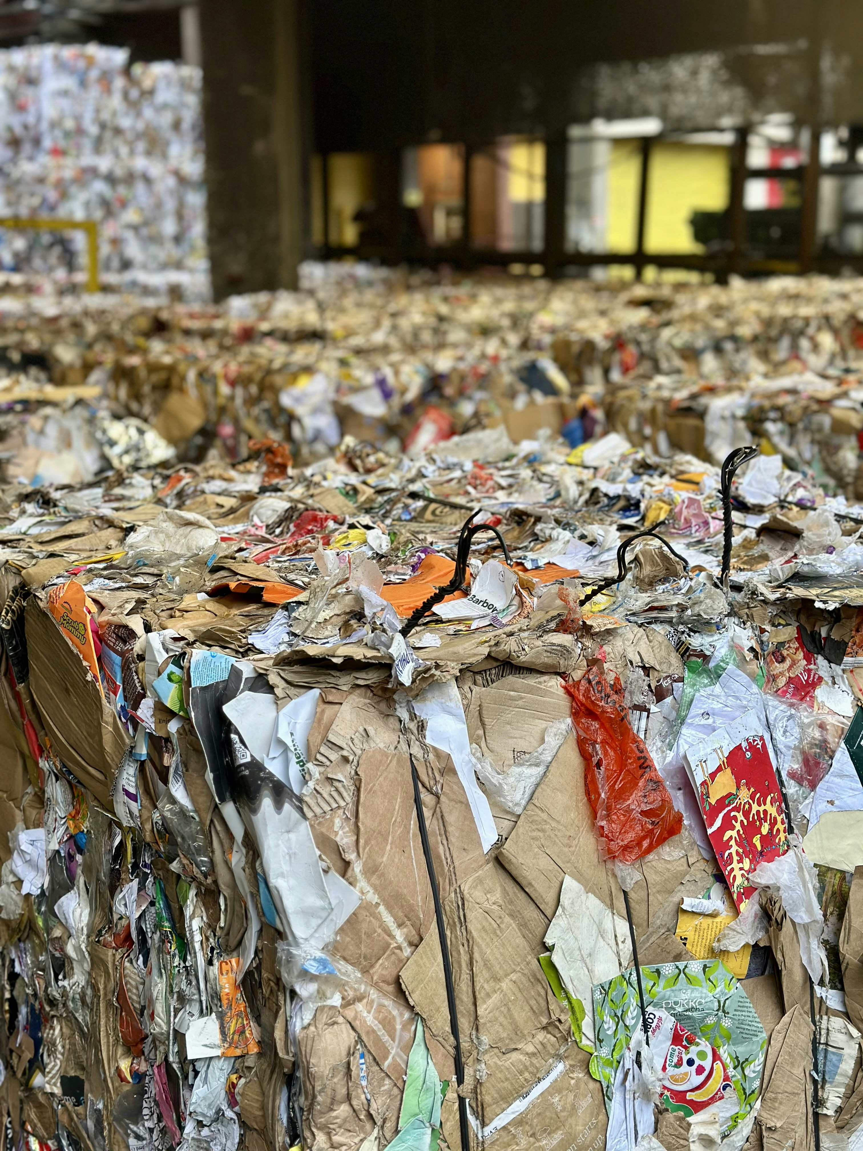 A large amount of bags of trash in a warehouse