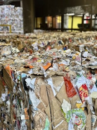 A large amount of bags of trash in a warehouse