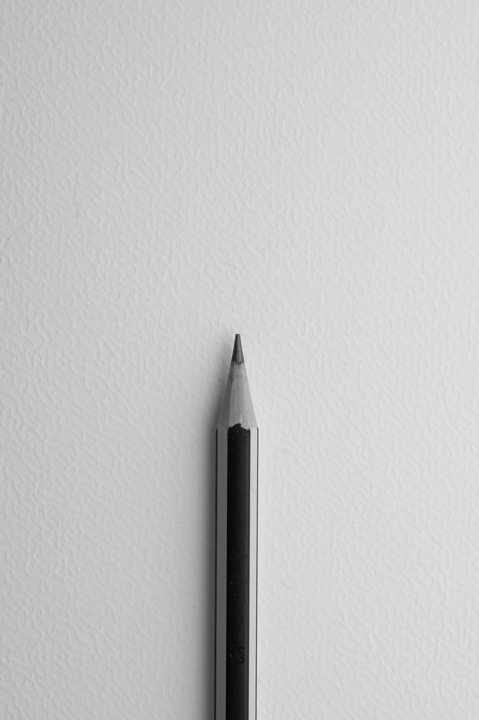 A black and white photo of a pencil