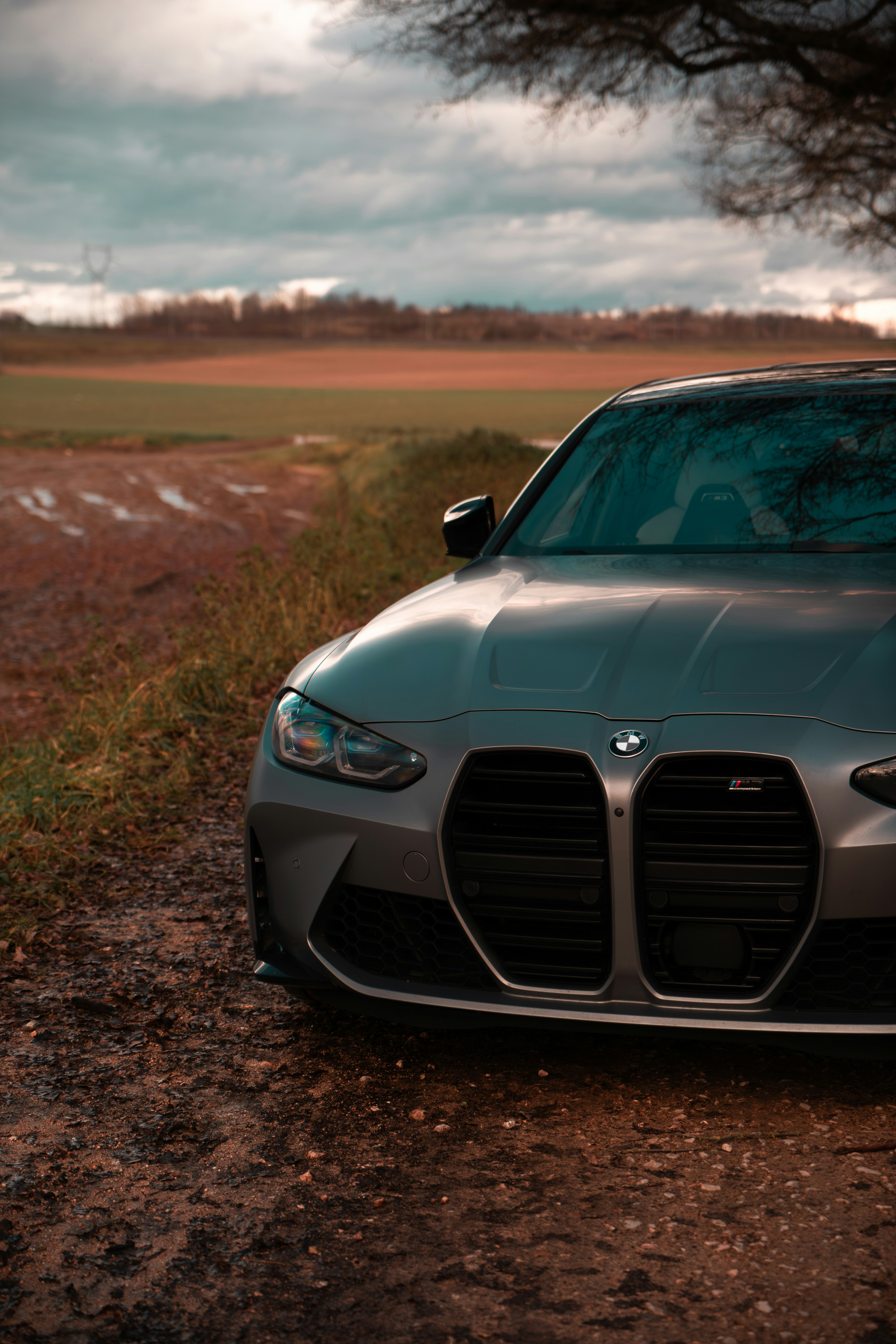 A car parked on the side of a dirt road