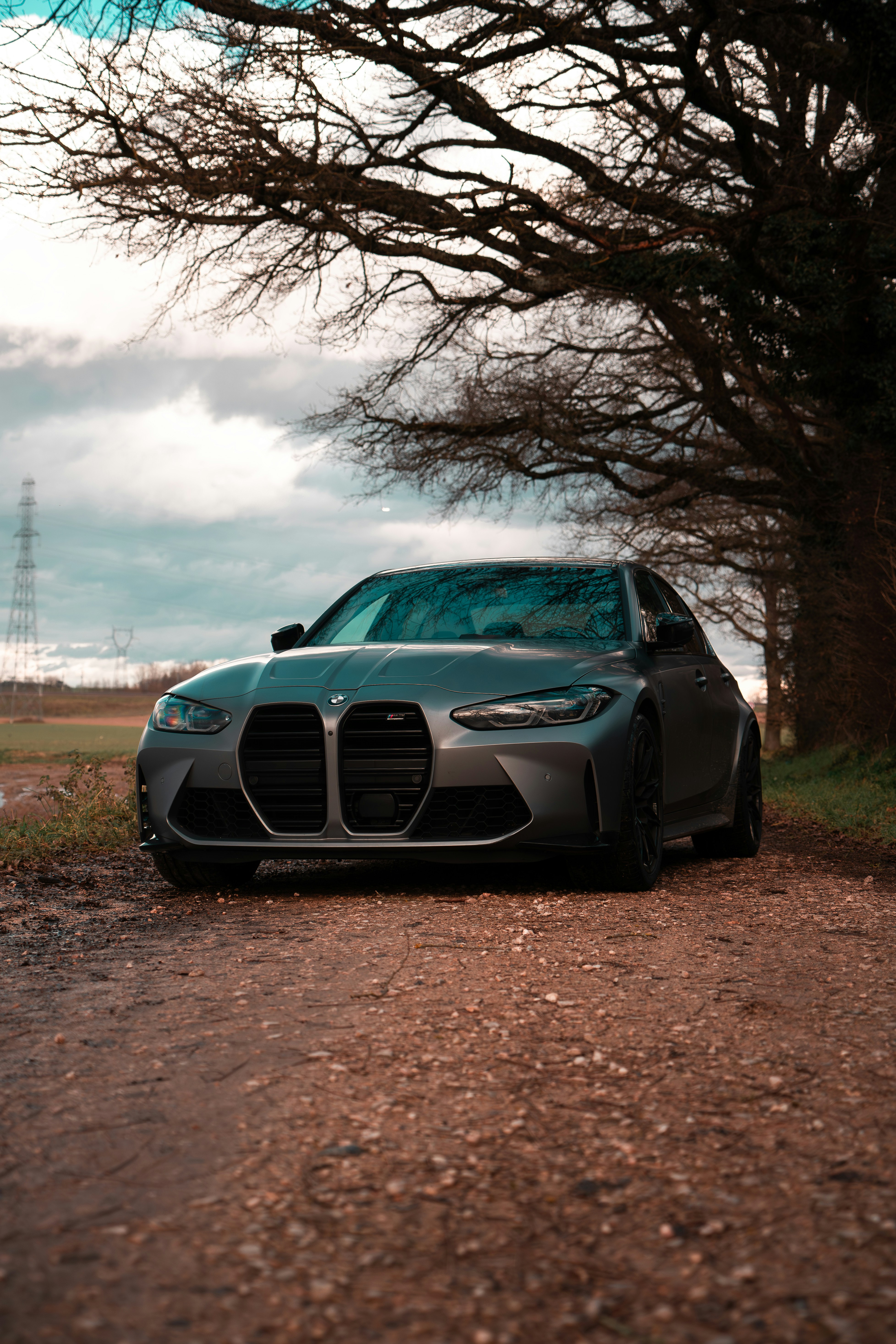 A car parked on the side of a dirt road