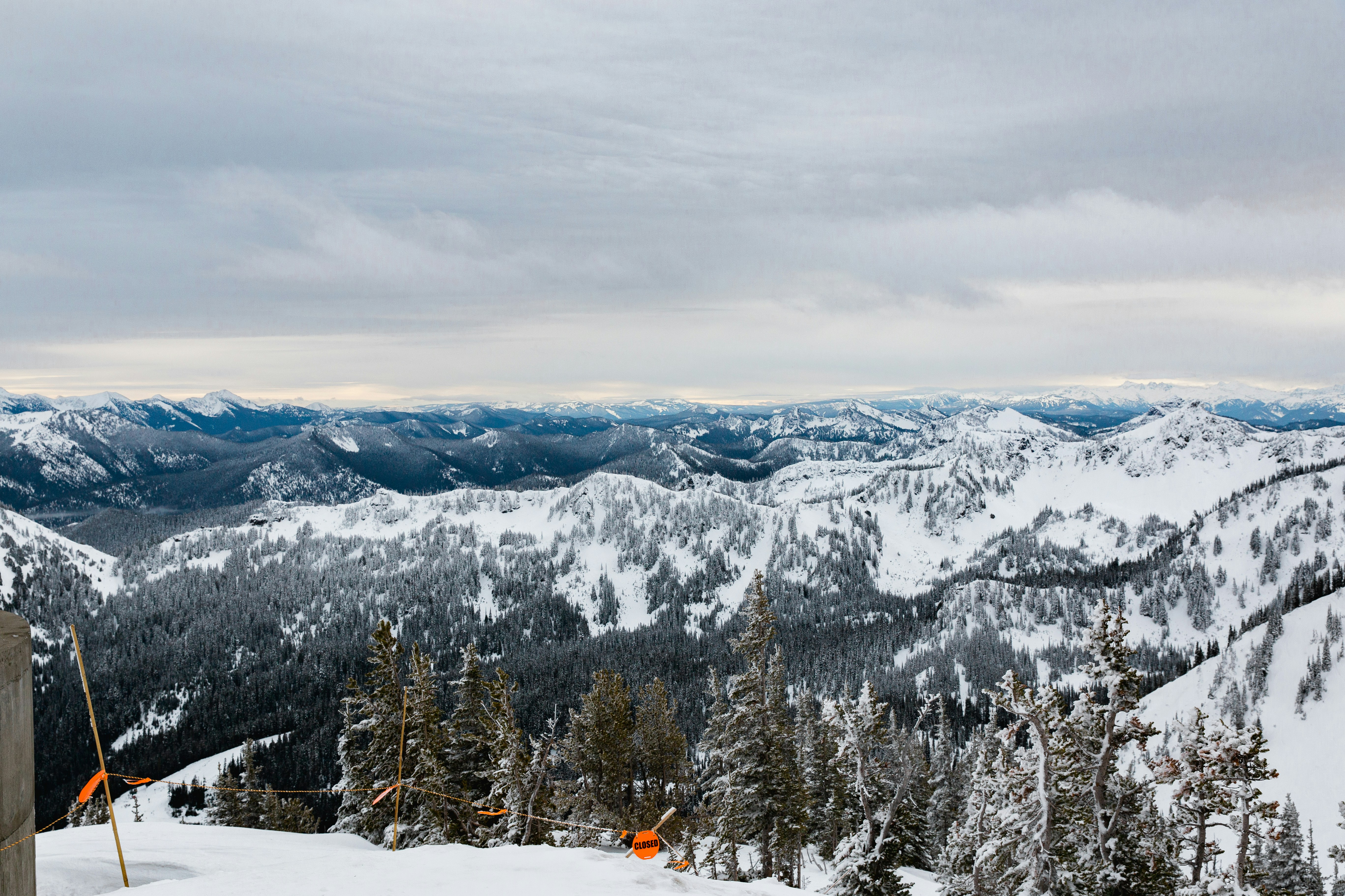 A man standing on top of a snow covered ski slope