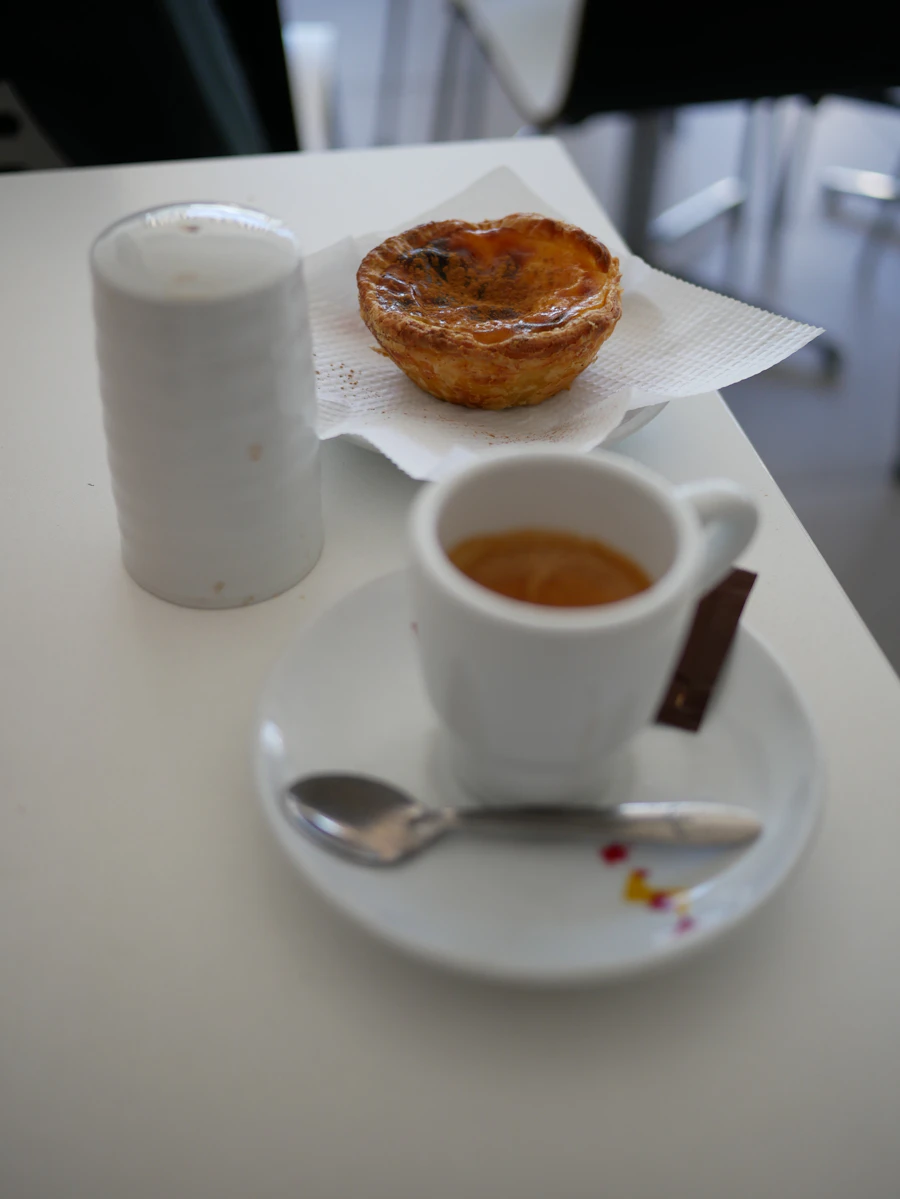 Espresso next to a golden pastry