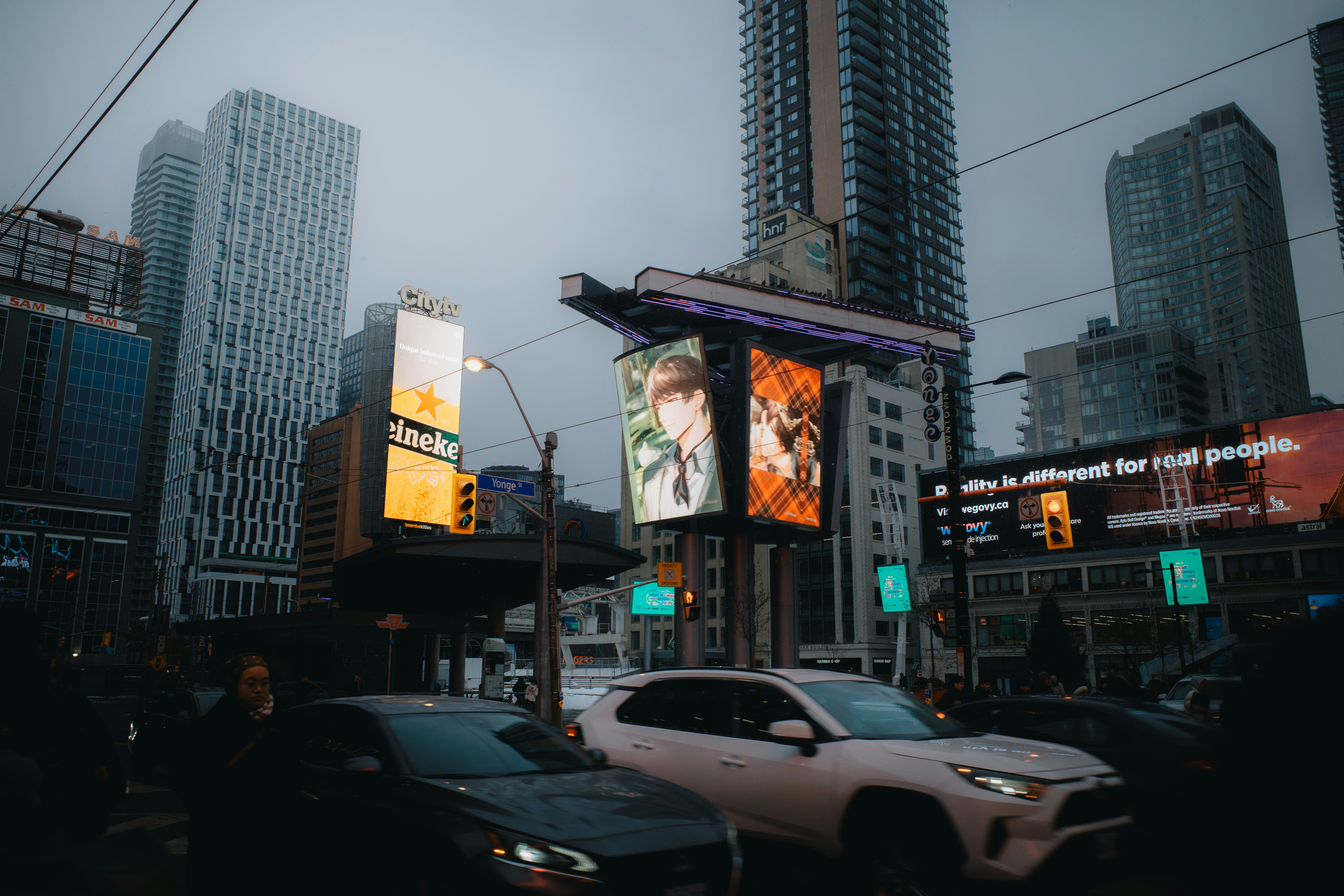 A city street filled with traffic and tall buildings