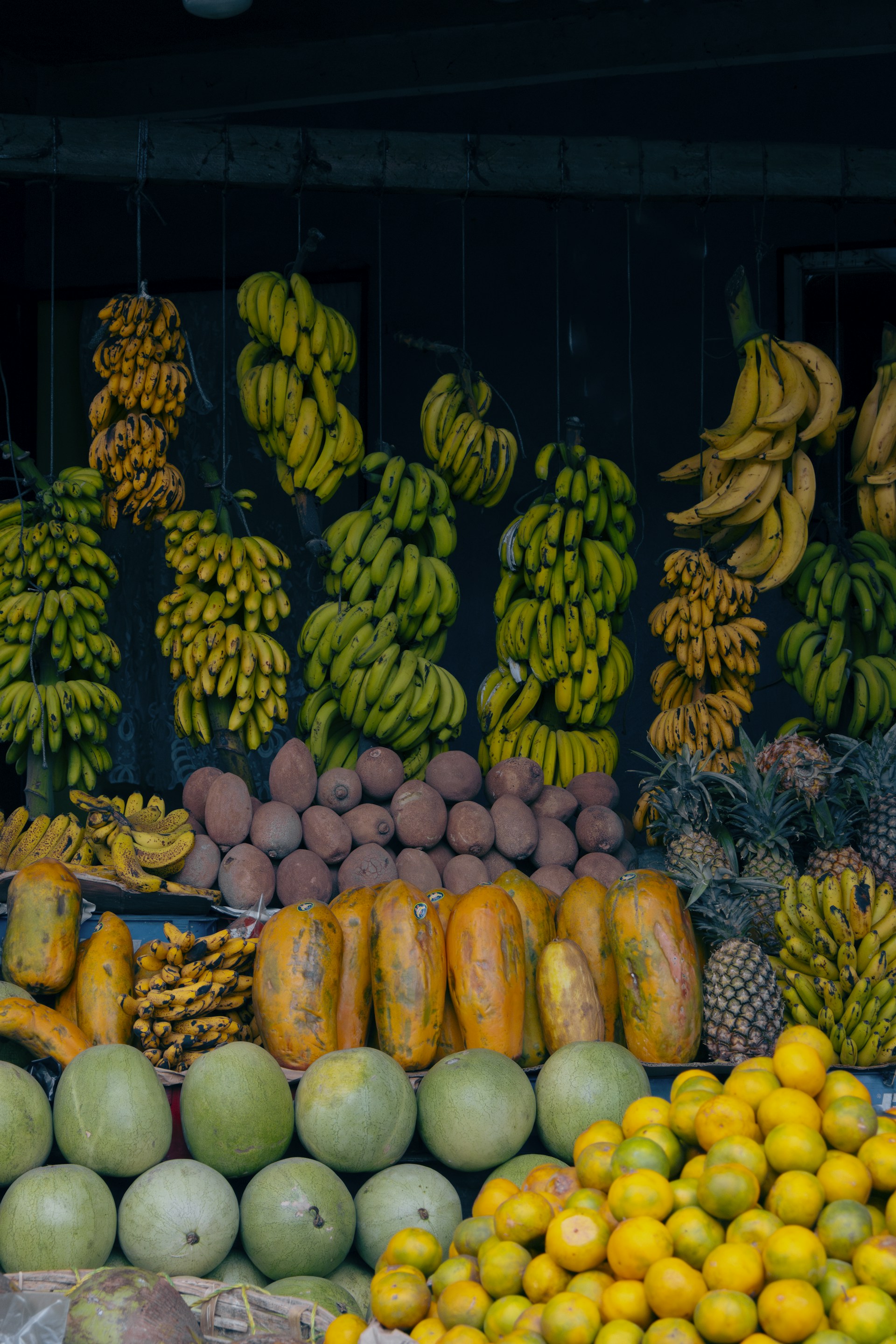 A fruit stand with many different types of fruit