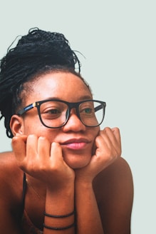A woman with glasses is posing for a picture