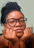 A woman with glasses is posing for a picture