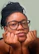 A woman with glasses is posing for a picture