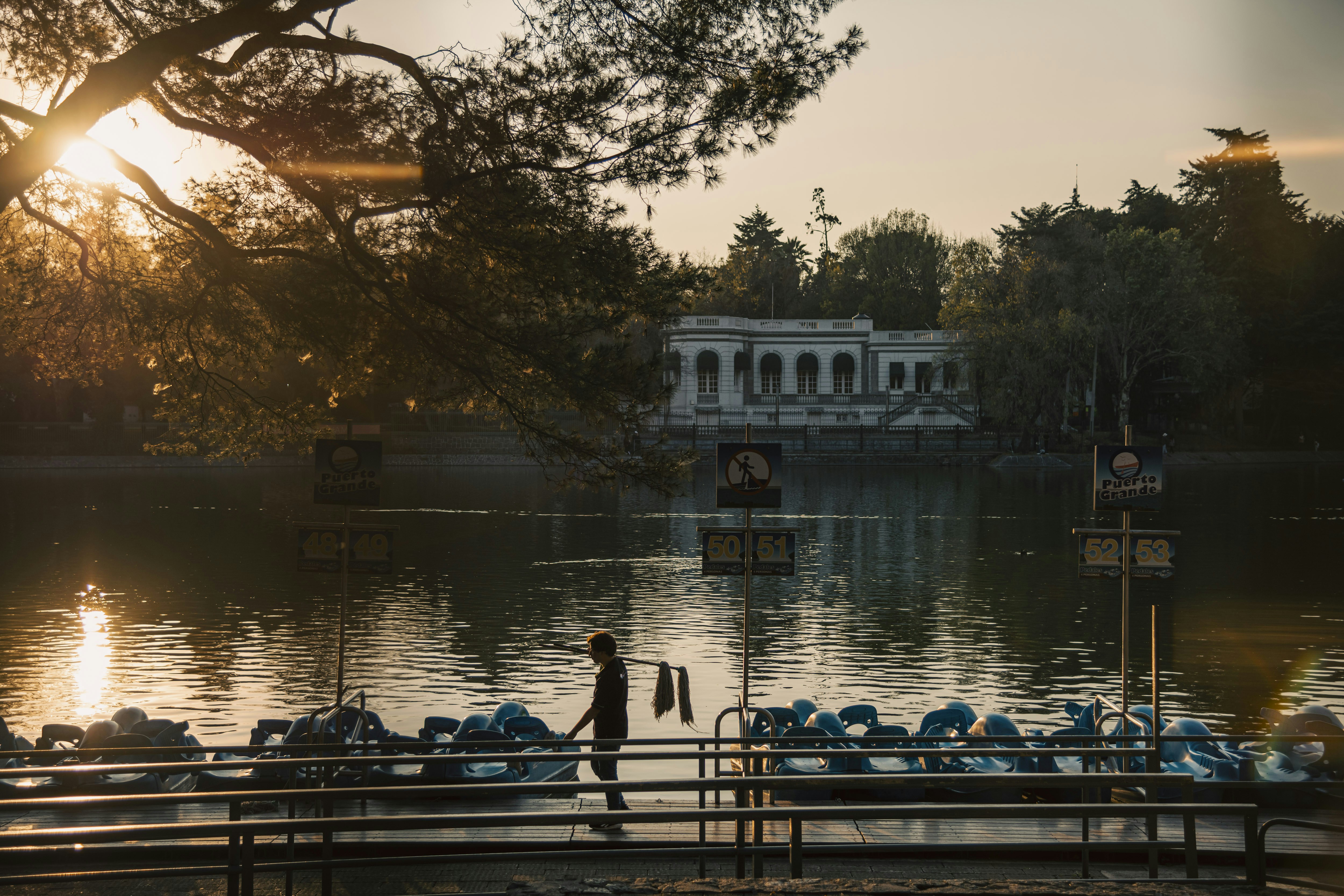 A man is standing on a dock near the water