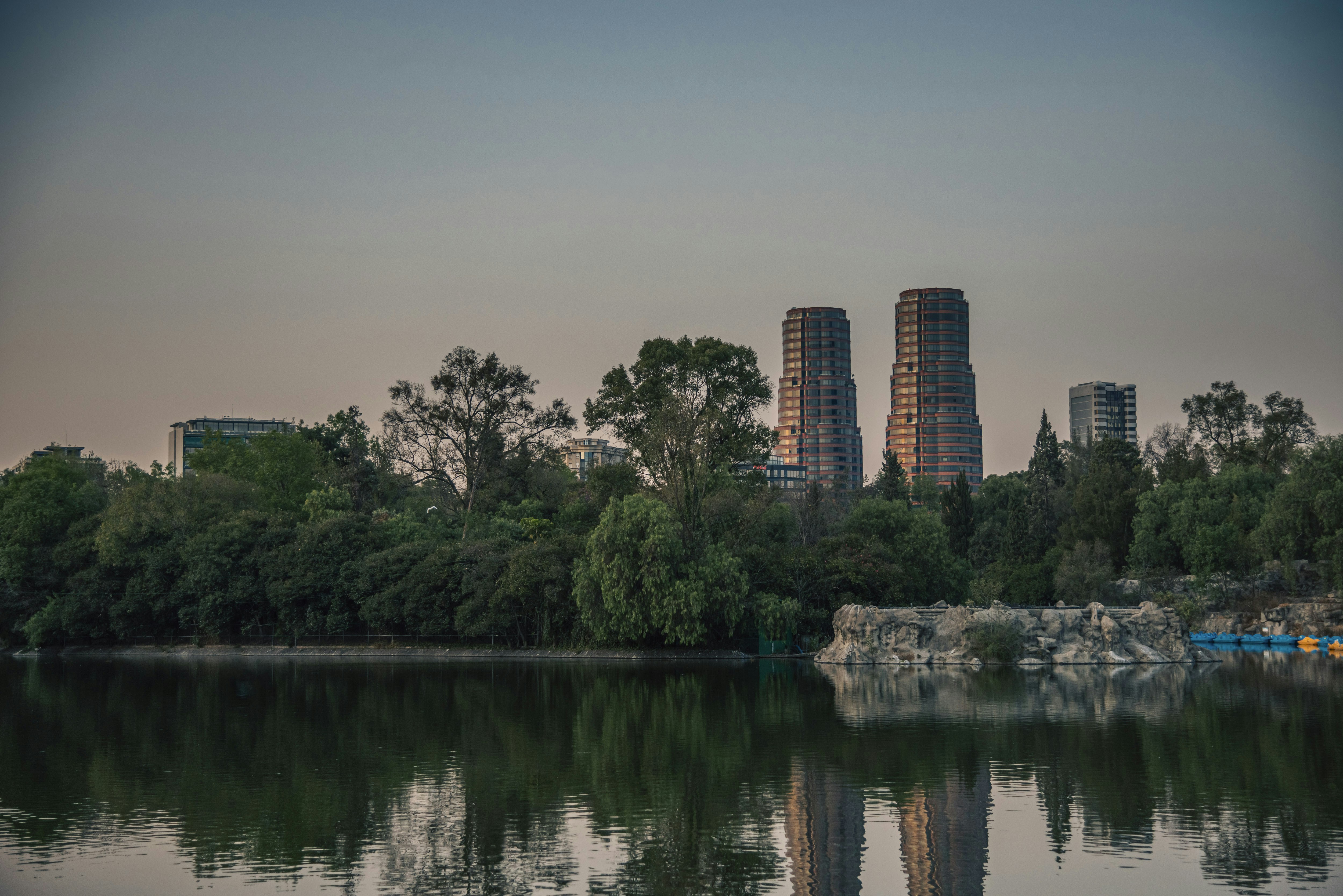 A body of water surrounded by trees and buildings
